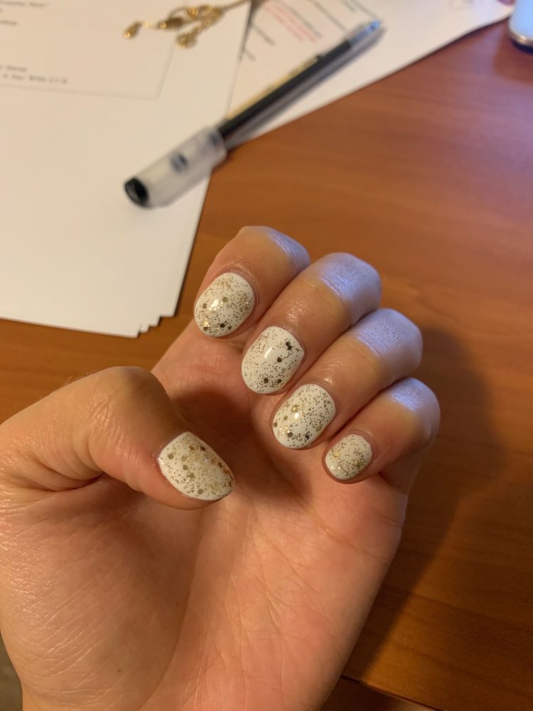 White speckled manicure on hand